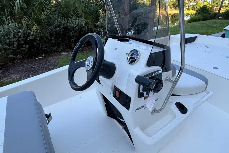 Slide: The Image of 2026 Mako Pro Skiff 15 CC boat console with steering wheel and controls. - 5