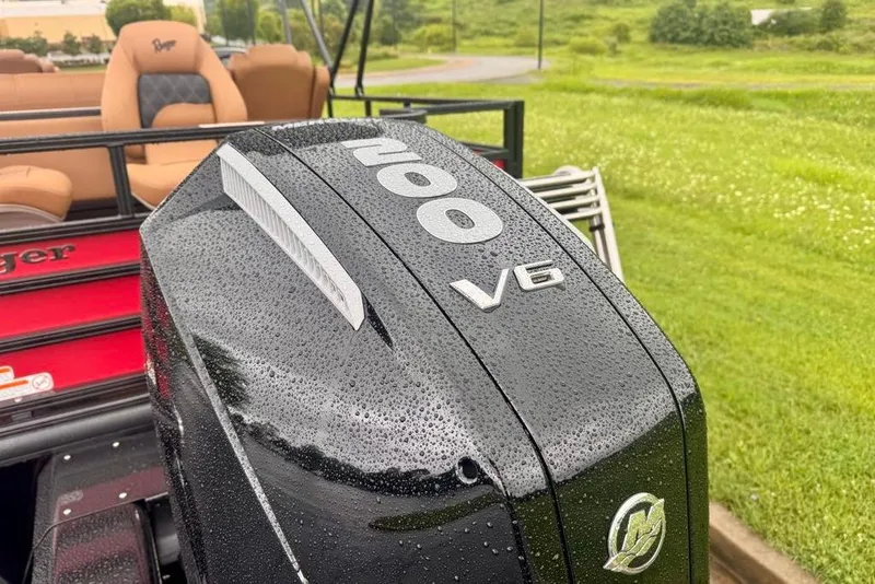 Slide: The Image of 2026 Ranger 223FC boat with V6 engine, wet from rain, in a grassy area. - 17