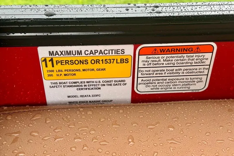 Slide: The Image of Boat capacity warning label for Ranger 223FC, 2026 model, with safety instructions and limits. - 7