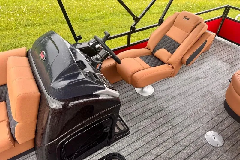 Slide: The Image of 2026 Ranger 223FC boat interior with tan and black seating, steering console, and wood-style flooring. - 14
