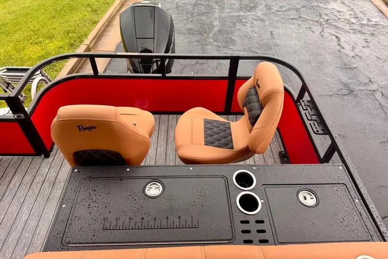 Slide: The Image of 2026 Ranger 223FC boat interior with tan seats, red accents, and fishing station. - 12