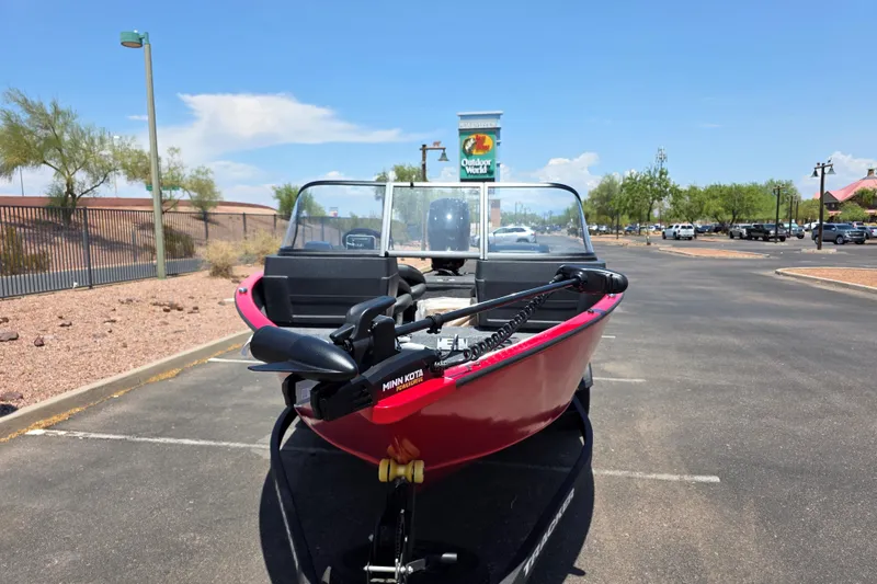 Slide: The Image of 2026 Tracker Pro Guide V-175 WT boat in parking lot, featuring Minn Kota motor. - 2