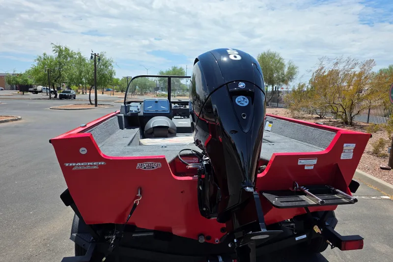 Slide: The Image of 2026 Tracker Pro Guide V-175 WT boat with powerful outboard motor in a parking lot. - 3