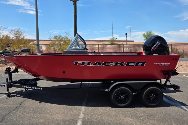 The Image of 2026 Tracker Pro Guide V-175 WT boat on trailer, red exterior, parked outdoors. - 0