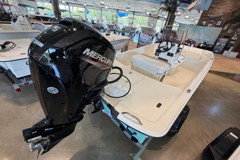 Slide: The Image of 2026 Mako Pro Skiff 17 CC boat with Mercury engine displayed in showroom. - 4