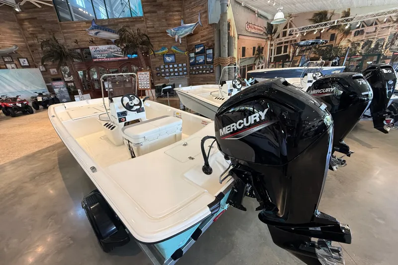 Slide: The Image of 2026 Mako Pro Skiff 17 CC boat with Mercury outboard motor in showroom. - 3