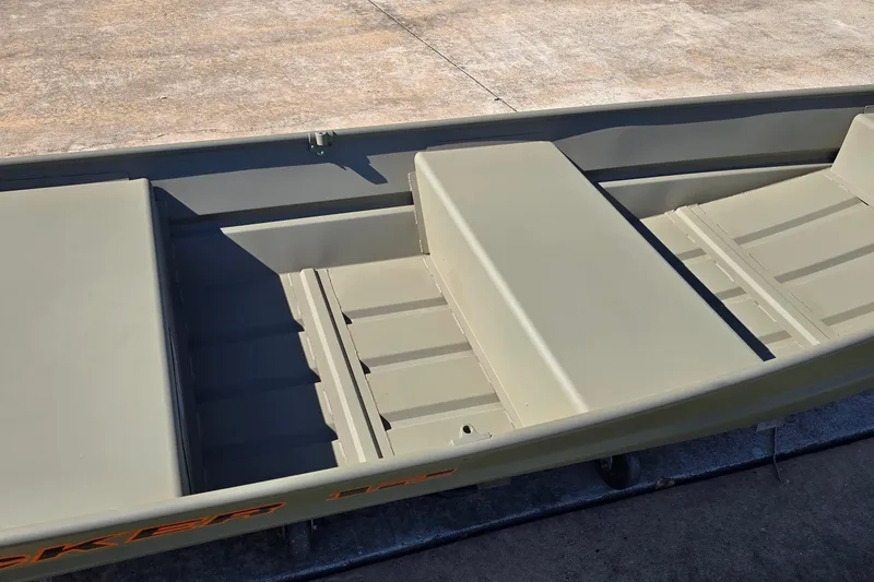 Slide: The Image of 2026 Tracker Grizzly 12 Jon boat interior with bench seating and durable construction. - 3