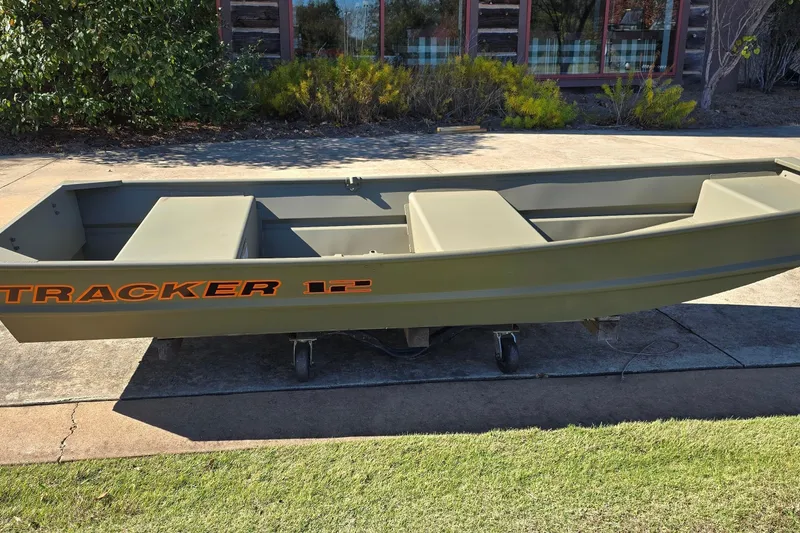 Slide: The Image of 2026 Tracker Grizzly 12 Jon boat on display outdoors, showcasing its sturdy design. - 5