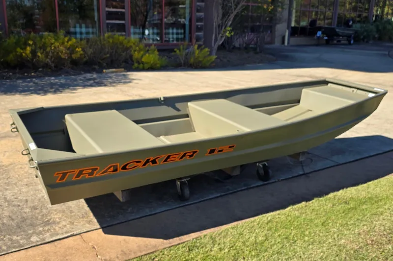 Slide: The Image of 2026 Tracker Grizzly 12 Jon boat on display outdoors, showcasing its sturdy design. - 4
