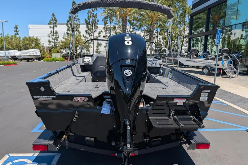 Slide: The Image of 2026 Tracker Pro Guide V-175 Combo boat with 150 HP engine, parked outdoors. - 5