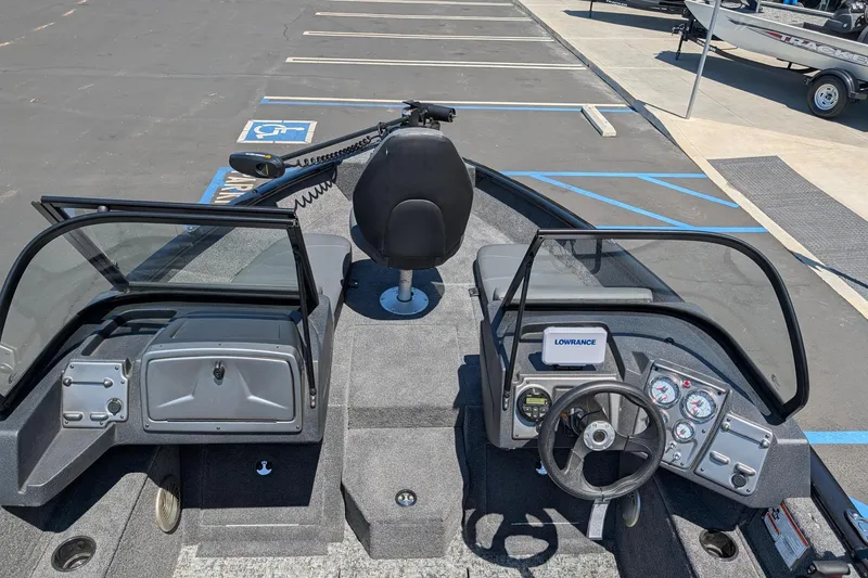 Slide: The Image of 2026 Tracker Pro Guide V-175 Combo boat interior with steering wheel and Lowrance electronics. - 6