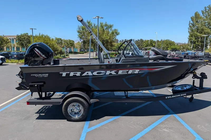 The Image of 2026 Tracker Pro Guide V-175 Combo boat on trailer in parking lot. - 0