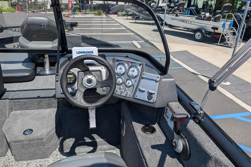 Slide: The Image of Interior view of 2026 Tracker Pro Guide V-175 Combo boat with steering wheel and dashboard controls. - 8