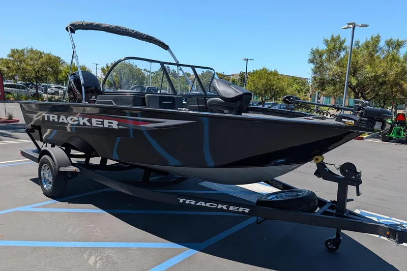 Slide: The Image of 2026 Tracker Pro Guide V-175 Combo boat on trailer in parking lot. - 3