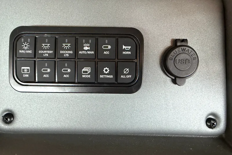 Slide: The Image of Control panel of 2026 Sun Tracker SportFish 20 DLX with USB port and various switches. - 14