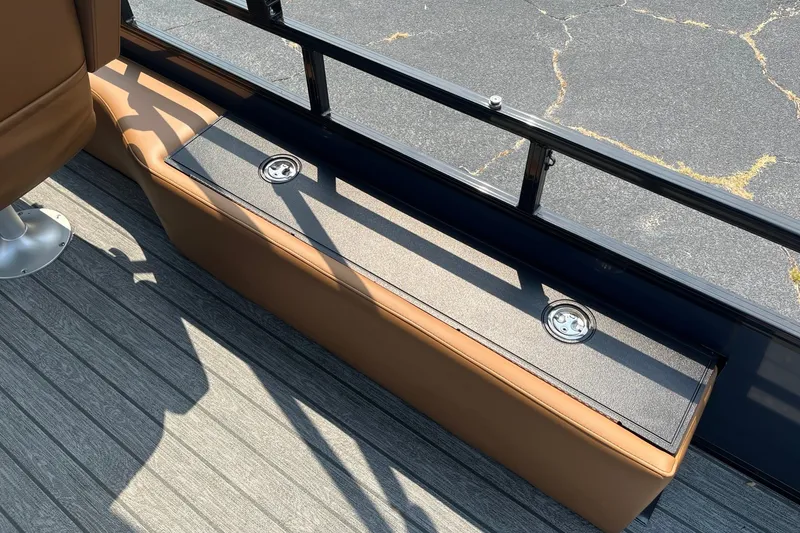 Slide: The Image of 2026 Ranger 220FC boat interior with brown seating and metal fixtures. - 10