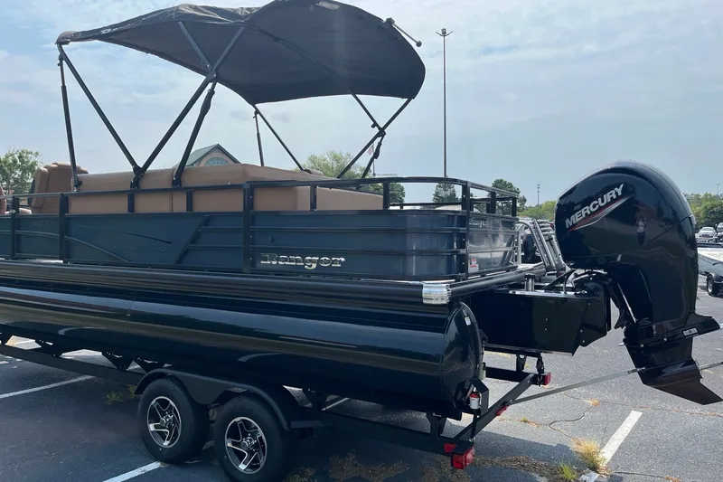 Slide: The Image of 2026 Ranger 220FC pontoon boat with Mercury engine in a parking lot. - 4