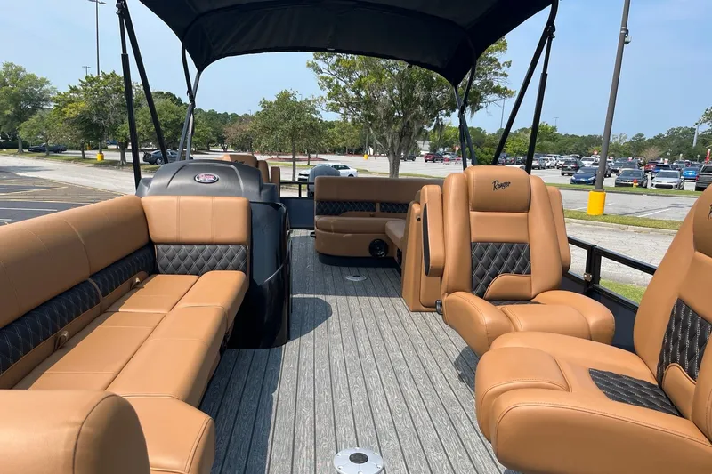 Slide: The Image of Luxurious 2026 Ranger 220FC boat interior with tan leather seating and canopy. - 6