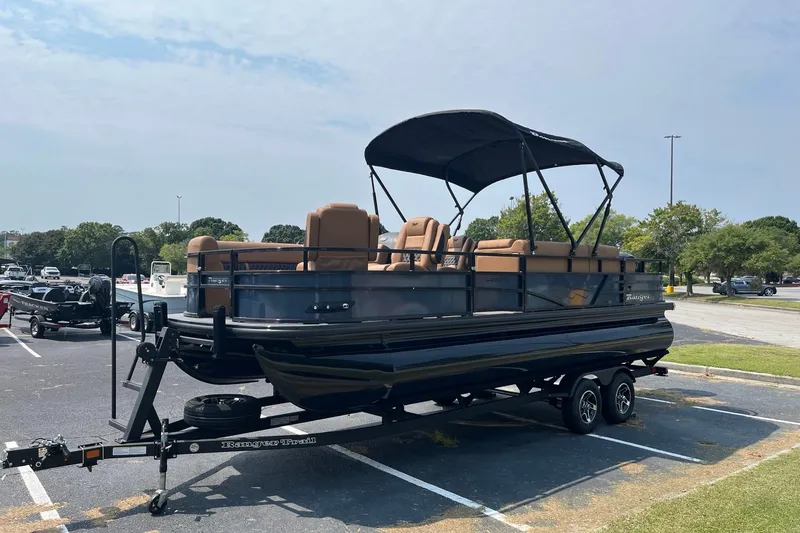 Slide: The Image of 2026 Ranger 220FC pontoon boat with canopy on trailer in parking lot. - 1