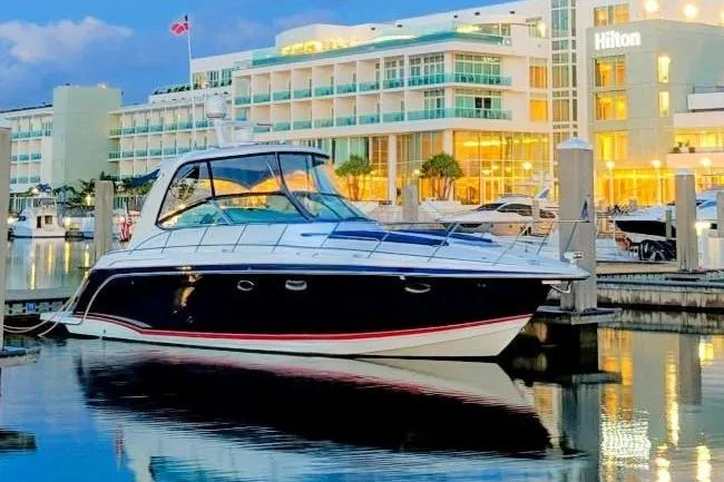 The Image of 2008 Formula 40 Performance Cruiser docked at marina, illuminated hotel in background. - 0