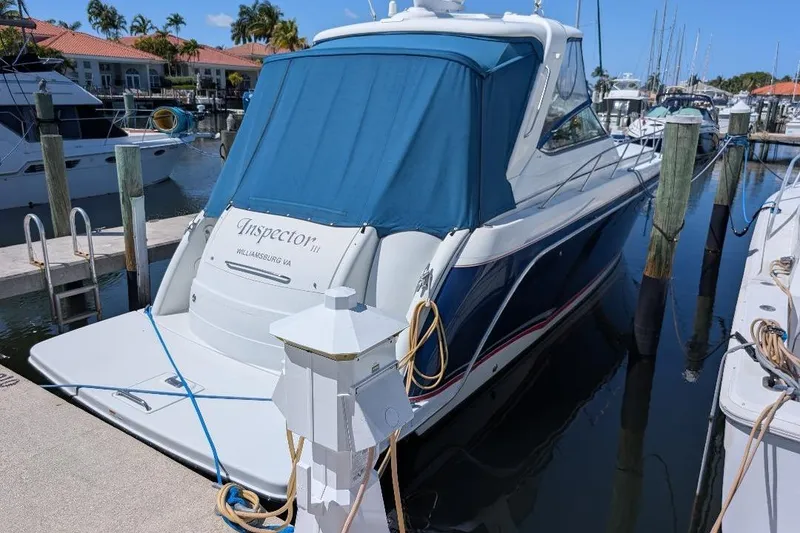 Slide: The Image of 2008 Formula 40 Performance Cruiser docked at marina, blue cover, sunny day. - 9