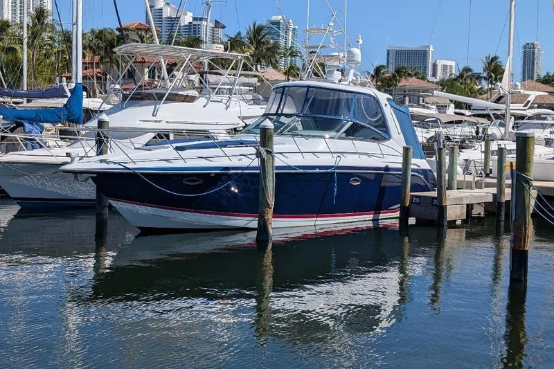 Slide: The Image of 2008 Formula 40 Performance Cruiser docked at marina with city skyline backdrop. - 4