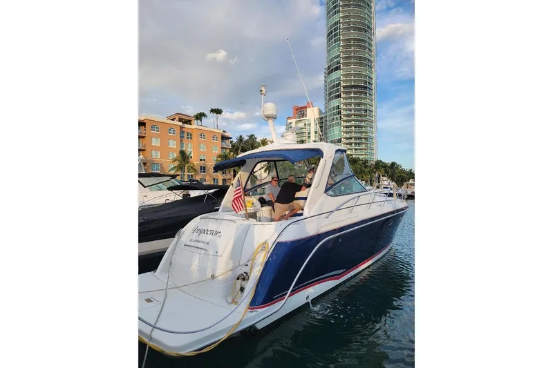 Slide: The Image of 2008 Formula 40 Performance Cruiser docked in a marina with cityscape background. - 7