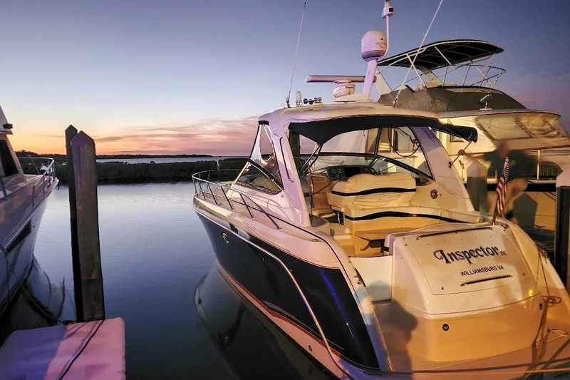 Slide: The Image of 2008 Formula 40 Performance Cruiser docked at sunset, reflecting on calm water. - 2
