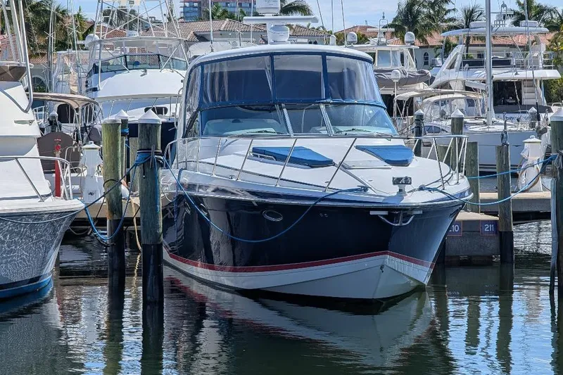 Slide: The Image of 2008 Formula 40 Performance Cruiser docked at marina, surrounded by other boats. - 6