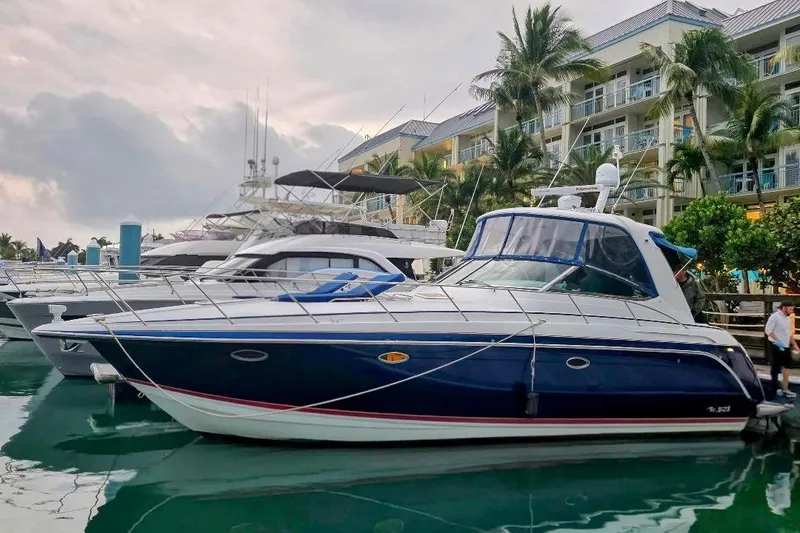Slide: The Image of 2008 Formula 40 Performance Cruiser docked at marina, surrounded by palm trees and buildings. - 3