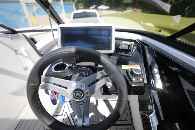 Slide: The Image of 2023 Yamaha Boats 252S dashboard with steering wheel and touchscreen display. - 7