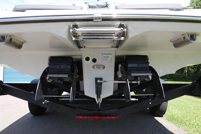 Slide: The Image of Rear view of 2023 Yamaha Boats 252S, showcasing dual engines and trailer. - 14