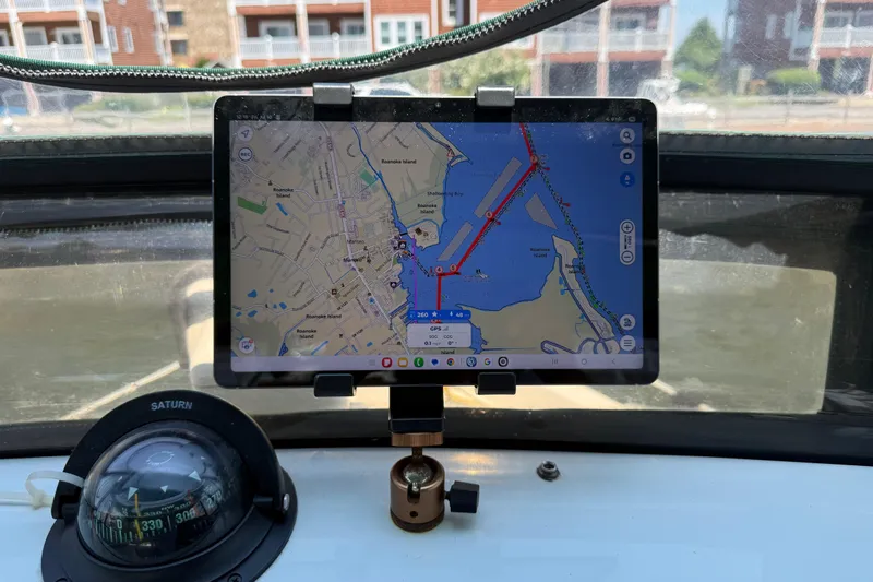 Slide: The Image of Tablet displaying navigation map on 2000 Mainship 390 Trawler's dashboard with compass. - 48