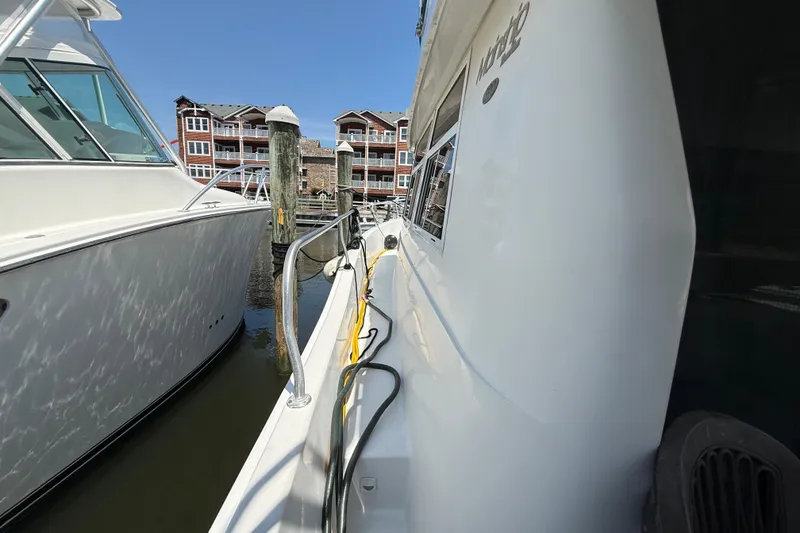 Slide: The Image of Side view of a 2000 Mainship 390 Trawler docked at a marina. - 15