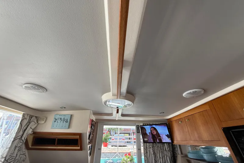 Slide: The Image of Interior of 2000 Mainship 390 Trawler with modern decor and mounted TV. - 67