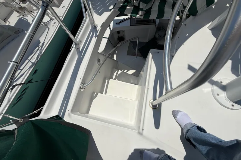 Slide: The Image of Stairs on a 2000 Mainship 390 Trawler, featuring stainless steel railings and white deck. - 35