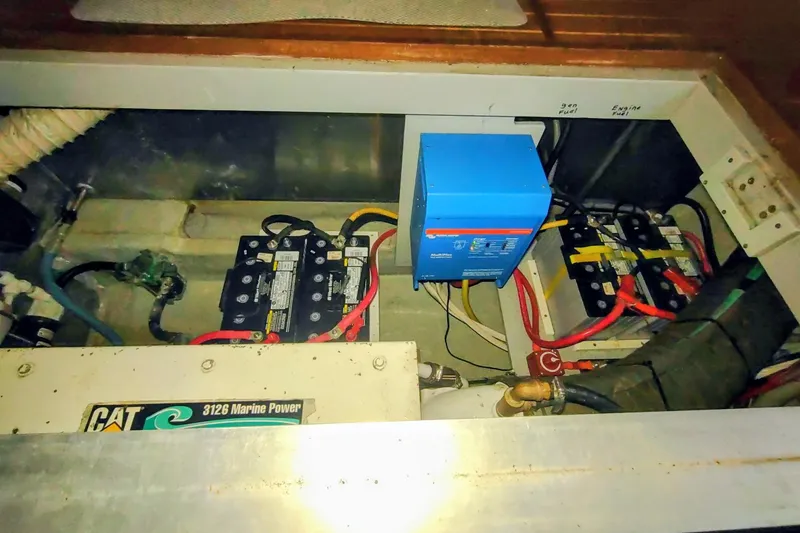 Slide: The Image of Engine compartment of a 2000 Mainship 390 Trawler with batteries and marine power components. - 83