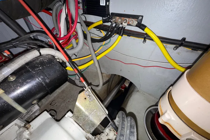 Slide: The Image of Engine room wiring of a 2000 Mainship 390 Trawler, showcasing cables and components. - 85
