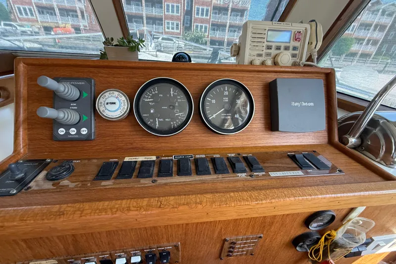 Slide: The Image of Control panel of a 2000 Mainship 390 Trawler with gauges and navigation equipment. - 60