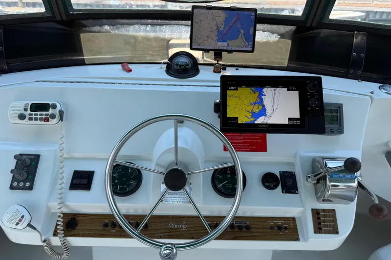 Slide: The Image of Helm of 2000 Mainship 390 Trawler with navigation equipment and steering wheel. - 46