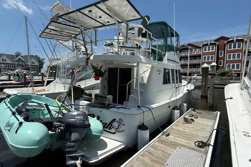 Slide: The Image of 2000 Mainship 390 Trawler docked with inflatable boat and Yamaha motor. - 2