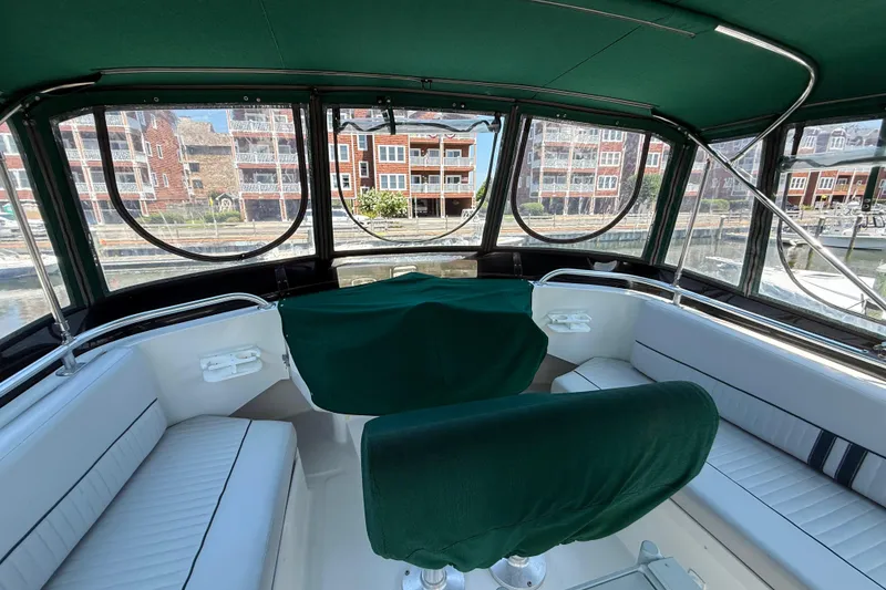 Slide: The Image of 2000 Mainship 390 Trawler interior with green upholstery and panoramic windows. - 17
