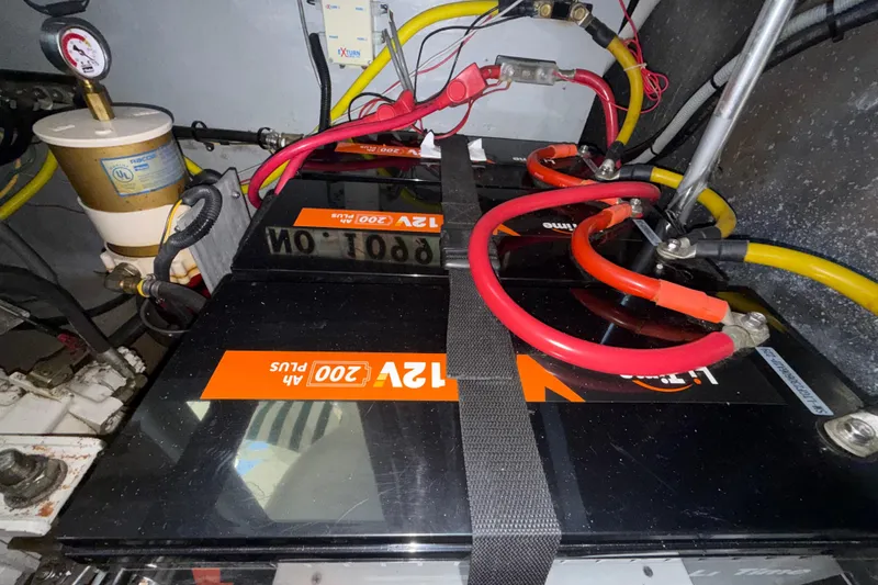 Slide: The Image of Battery setup in a 2000 Mainship 390 Trawler engine room with cables and filter. - 88