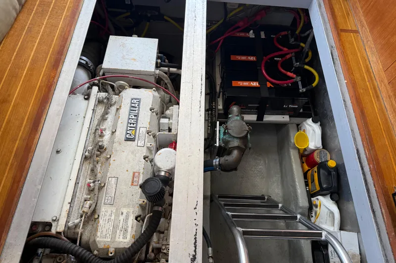 Slide: The Image of Engine compartment of a 2000 Mainship 390 Trawler with Caterpillar engine and batteries. - 80
