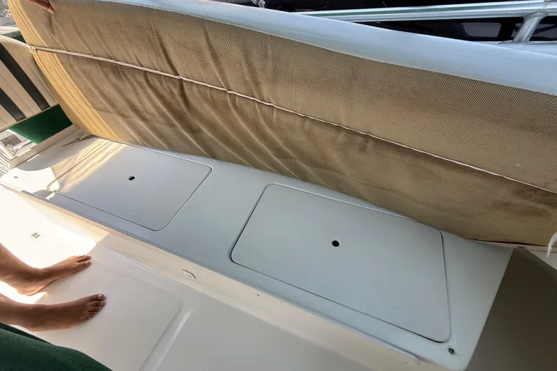 Slide: The Image of 2000 Mainship 390 Trawler deck with storage compartments and cushioned seating. - 24