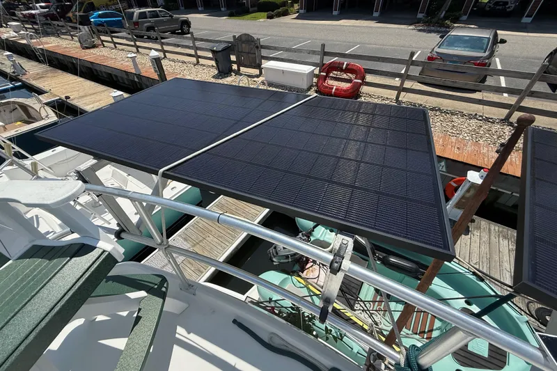 Slide: The Image of Solar panels on a 2000 Mainship 390 Trawler docked at a marina. - 31