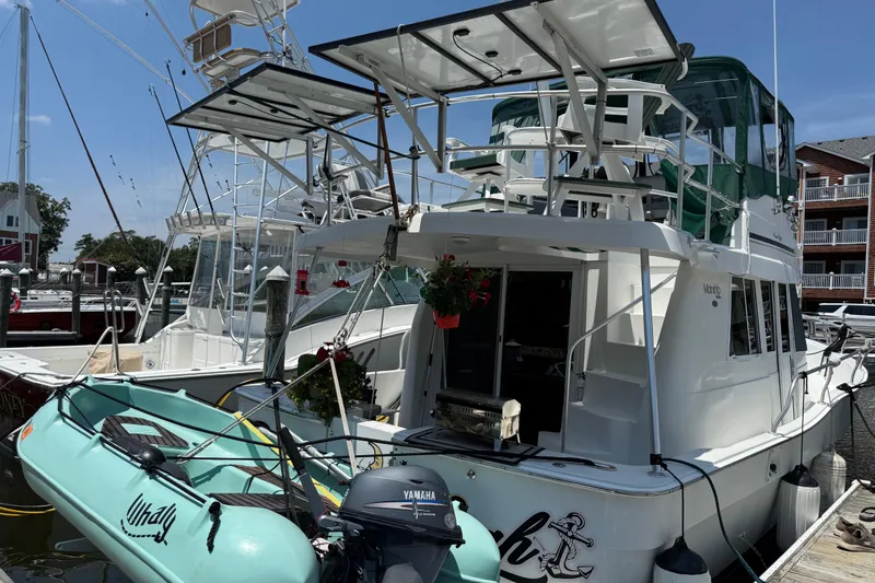 Slide: The Image of 2000 Mainship 390 Trawler docked with inflatable boat and Yamaha motor. - 5