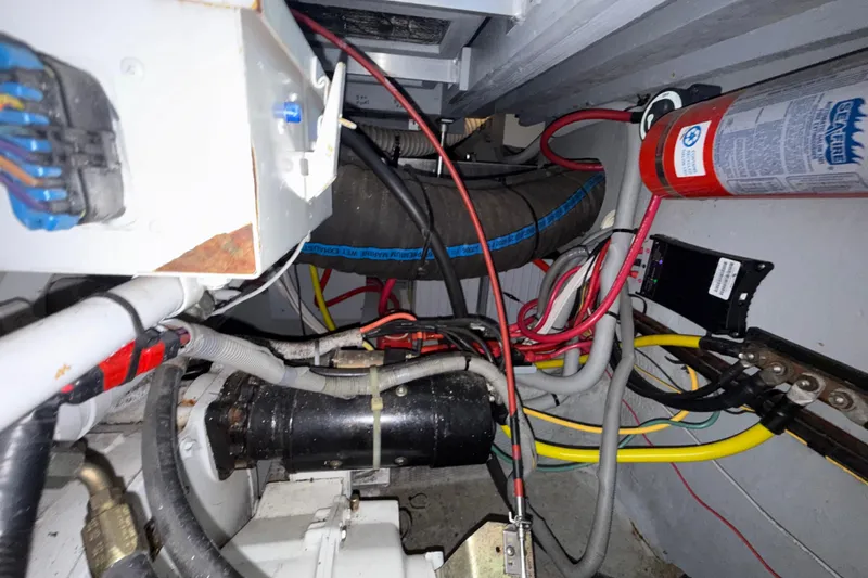 Slide: The Image of Engine room of 2000 Mainship 390 Trawler with wiring and fire extinguisher. - 87