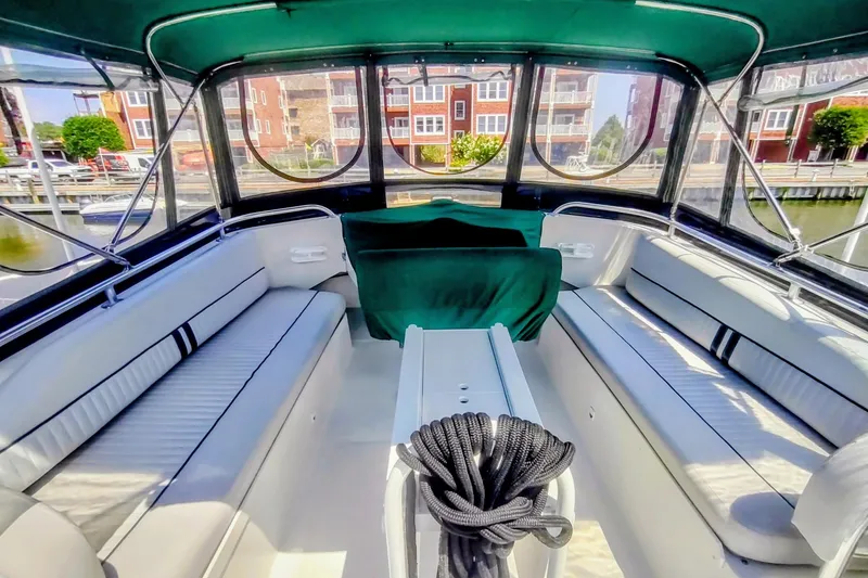 Slide: The Image of Interior view of a 2000 Mainship 390 Trawler with seating and windows. - 22