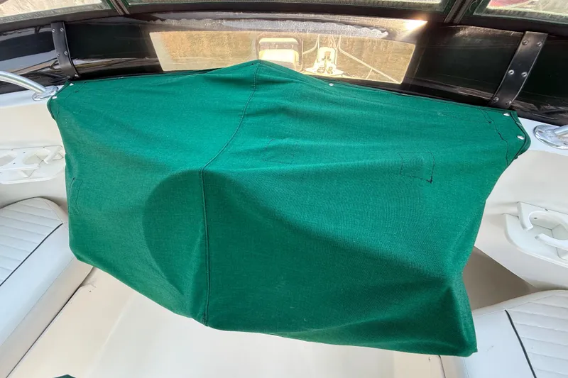 Slide: The Image of Green canvas cover on Mainship 390 Trawler dashboard, 2000 model. - 19